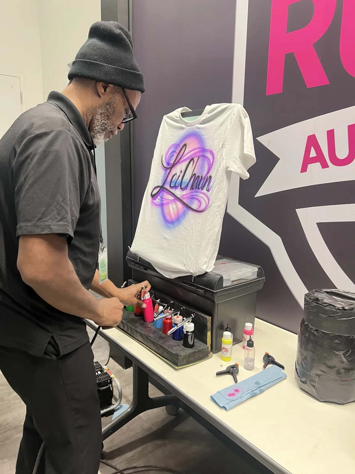 Artist painting a personalized T-shirt at the T-Mobile corporate event in Augusta