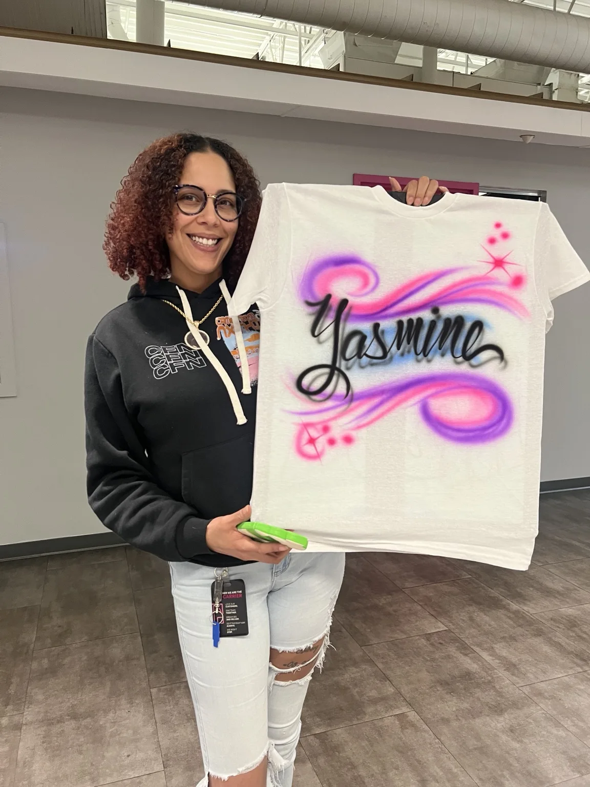 Guest displaying a pink and purple personalized name T-shirt at the Augusta T-Mobile event