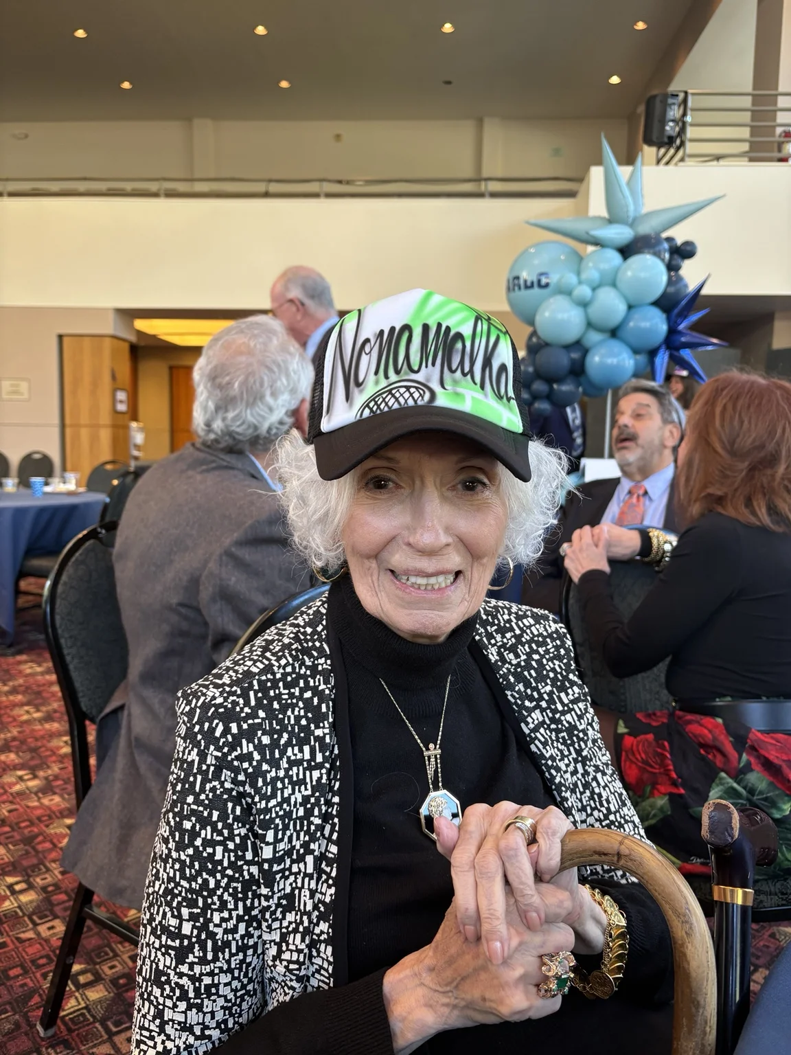 Guest wearing a green-and-black personalized trucker hat at a Monroe, Georgia corporate event